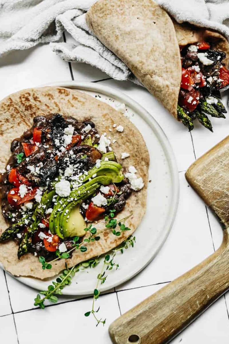 Colorful vegan wrap filled with fresh vegetables and plant-based protein